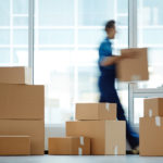 man who works for a moving company moving boxes